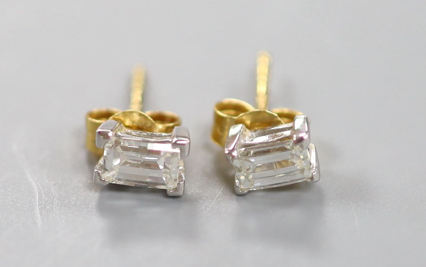 A pair of millennium cut diamond and gold stud earrings.